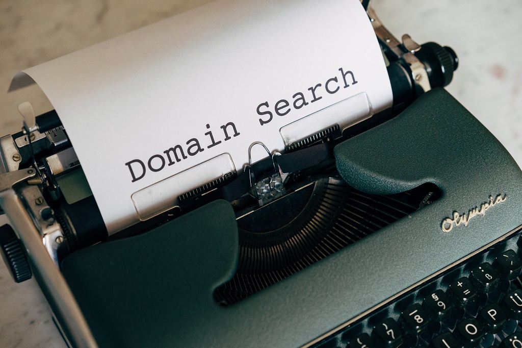 Typewriter with paper that says domain search